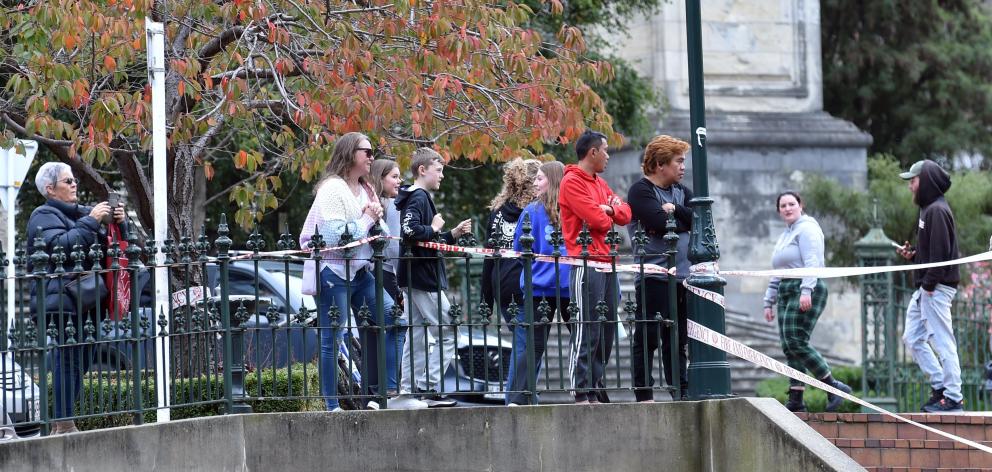 Curious onlookers survey the scene. PHOTO: PETER MCINTOSH