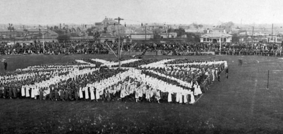 School children form a living flag of the Empire during a military pageant at Carisbrook, Dunedin...