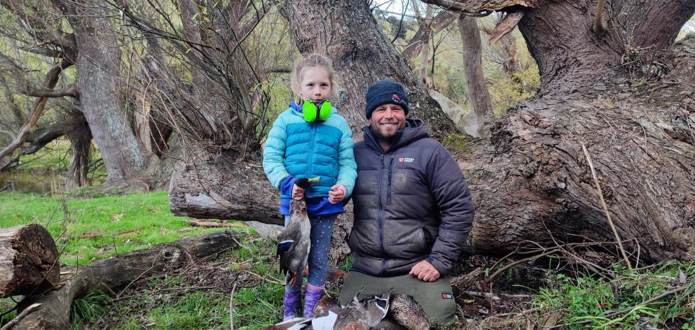 Bella Murray 7, of Lawrence, harvests wild tucker with her dad Paul Murray on opening day of the...