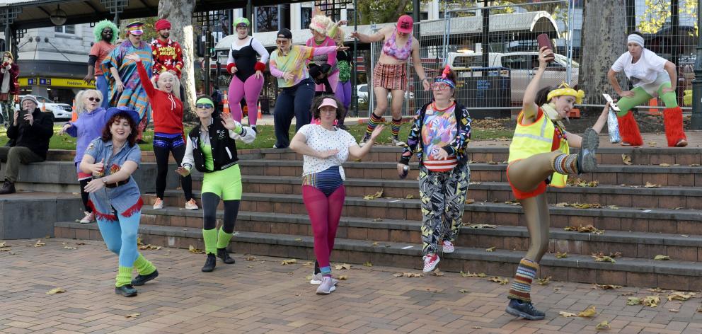 A lurid coloured 1980s-themed flash mob surprised onlookers when it descended on the Octagon as...