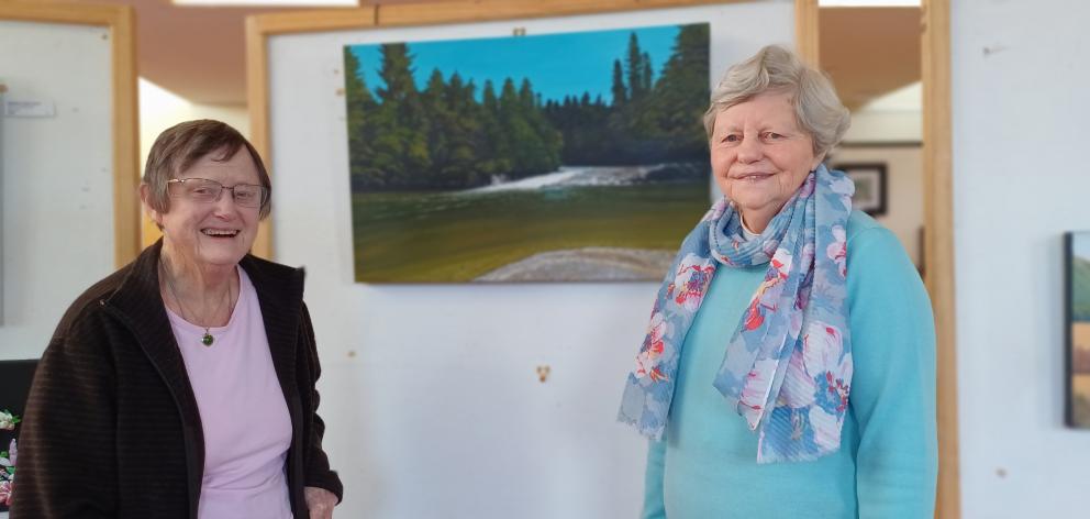 Anne Stringer (left) and Judy Gordon, both of Tapanui, admire Clinton artist David Mackie’s...