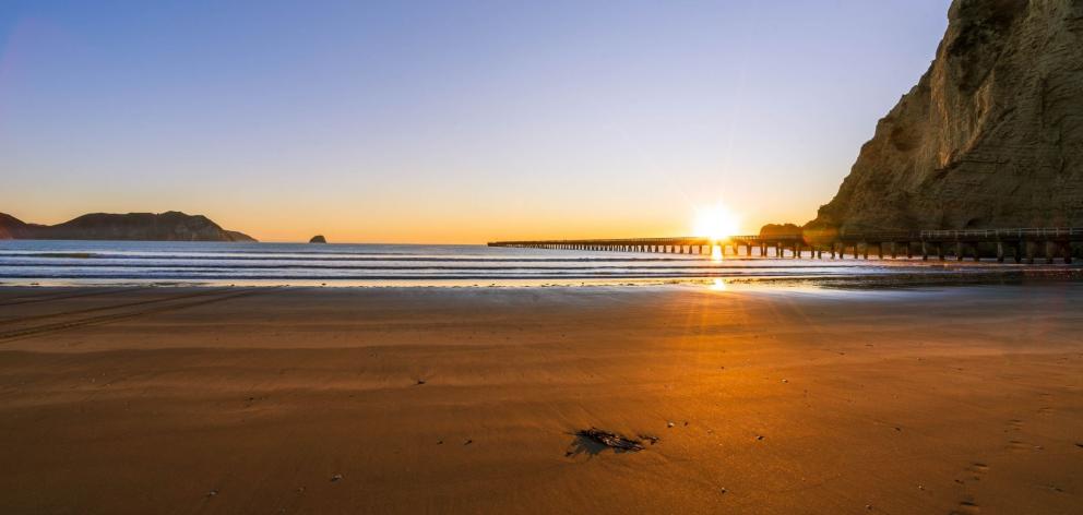 The golden sweep of Tolaga Bay with the Tolaga Bay Wharf (right). PHOTO: SUPPLIED