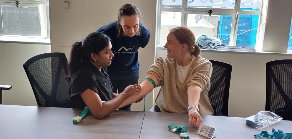 Lochani Kummara (left) practises taking a blood sample at a WellSouth Nurse Entry to Practice day...