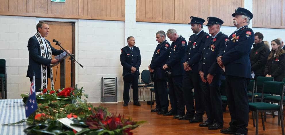 Members of the public and the Tarras Volunteer Fire Brigade listen to Upper Clutha Anglican...