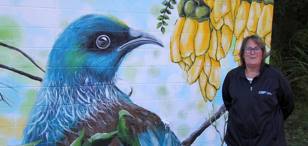 Cr Michelle Kennedy stands beside the new mural at Whisky Gully, Tapanui. PHOTO: NICK BROOK