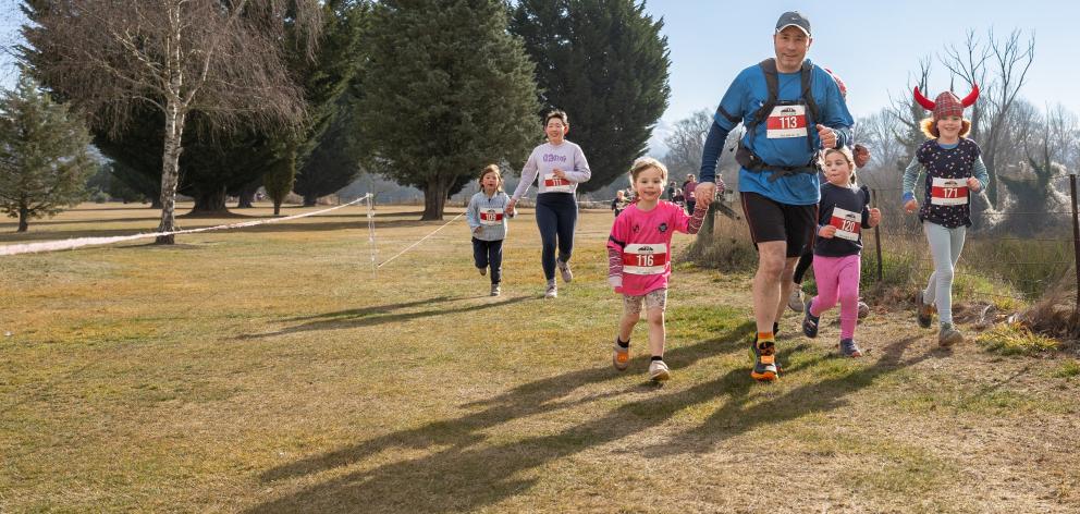 Simon Phillips and daughter Tessa (front left), 4, make good time on the 2.5km event. PHOTO:...