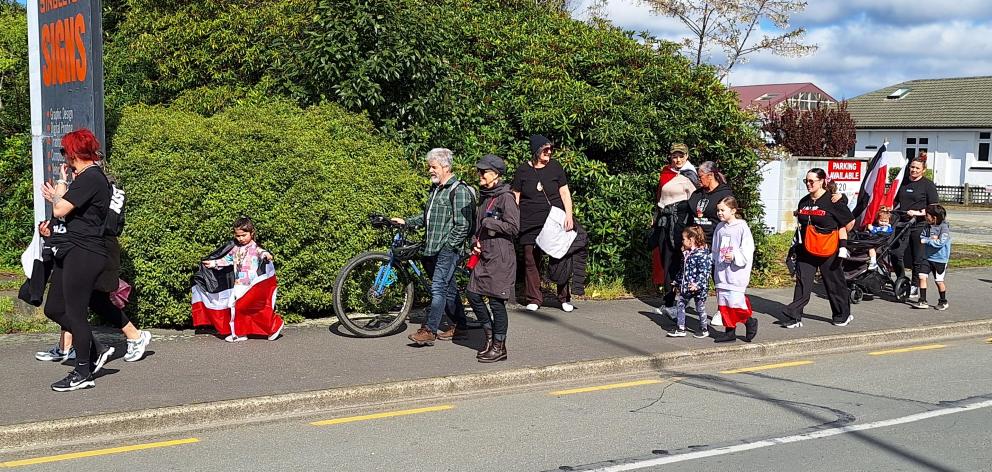People walk towards Invercargill’s Queens Park on Saturday during a hīkoi that started from...