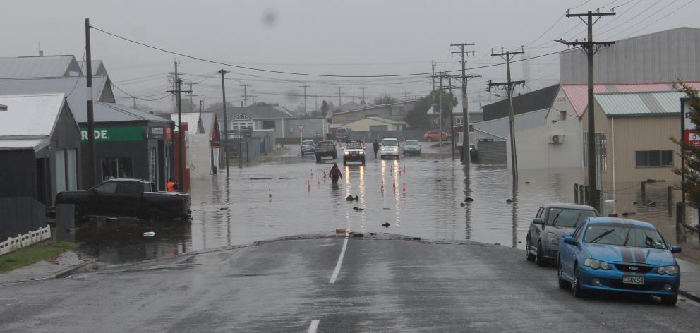 People were wading through water to get to their cars in Balclutha during Thursday’s flooding....