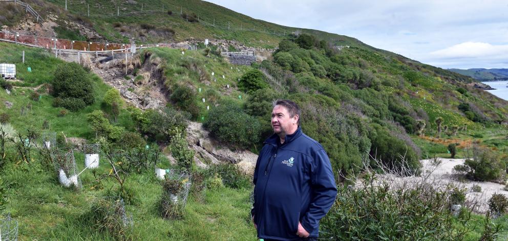 Hayden Coote, of Blue Penguins Pukekura, stands in front of a slip caused by flooding. PHOTOS:...