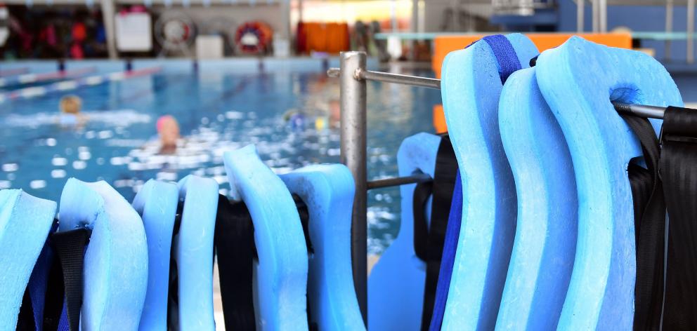 Aqua jogging belts on a stand beside the Moana Pool dive/lap pool where there is friction between...