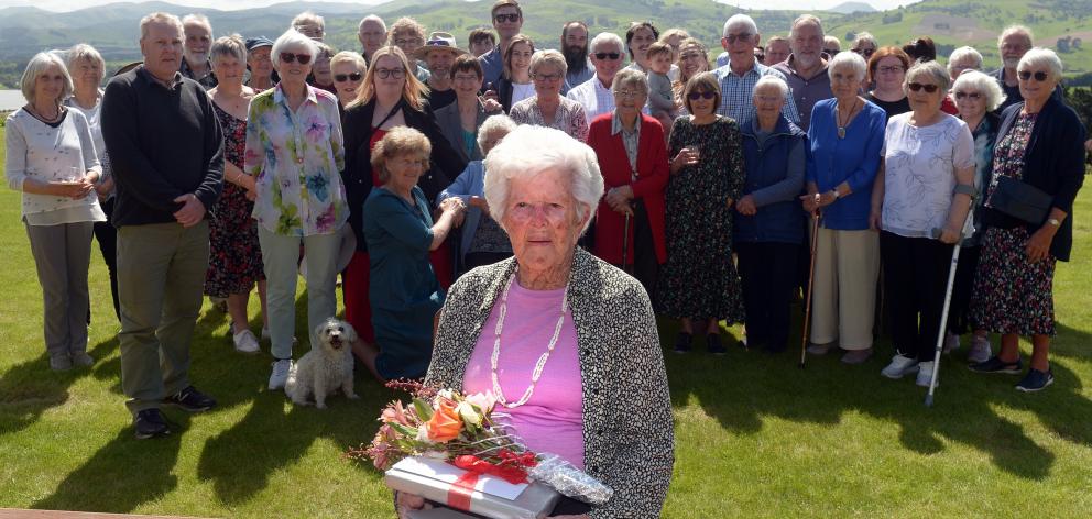 Doris Inglis holds gifts and flowers that were given to her by friends and family for her 100th...