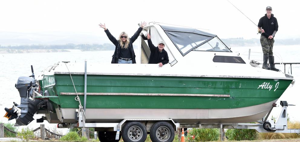 Standing on the prow of the boat which will be called Angela May at Moeraki yesterday is Moeraki...
