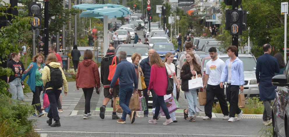 Drizzly weather did not put off Boxing Day shoppers in George St yesterday. PHOTO: GREGOR...