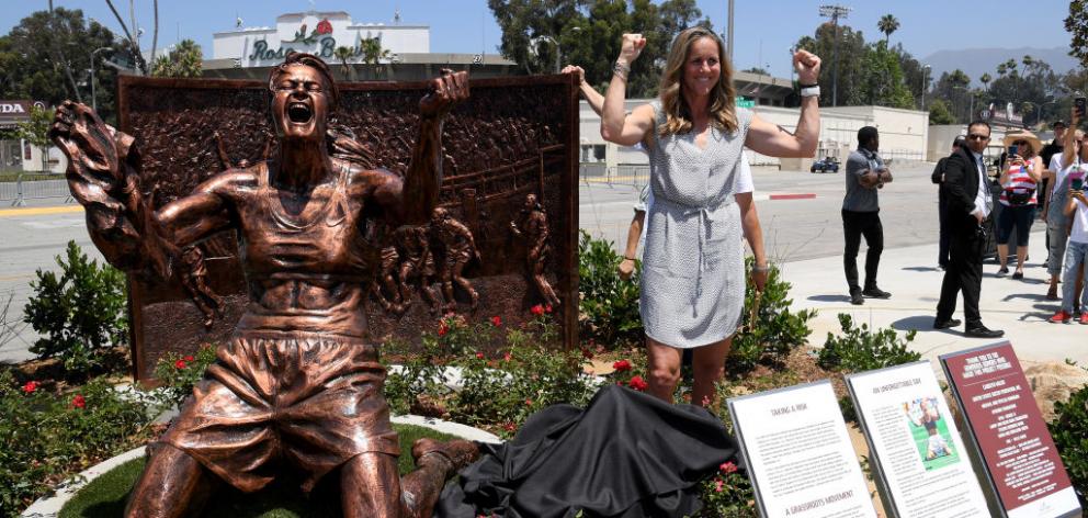 Brandi Chastain poses with the statue honouring the moment she celebrated the United States...