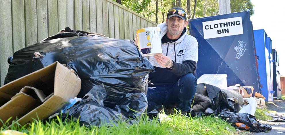 Pete Andrews is frustrated by repeated fly-tipping beside clothing bins in Taieri Rd. PHOTO:...