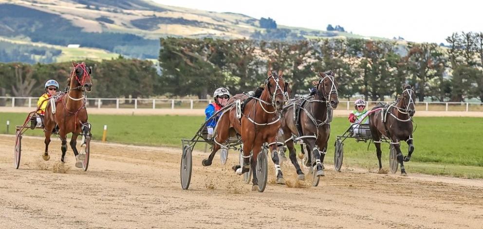 Commander Ben (centre) wins the Roxburgh Cup on Saturday for driver Kimberly Butt. PHOTO: MONICA...