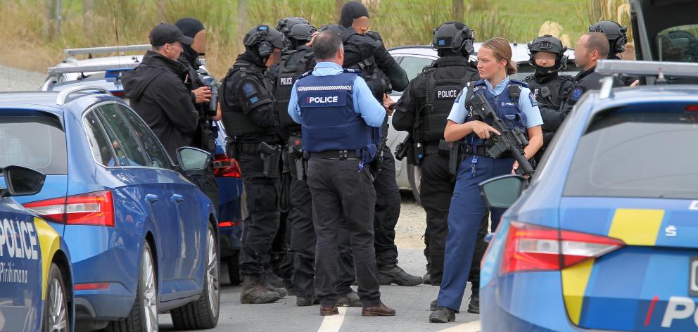 Constable Dent of Balclutha police (facing), on duty with tactical police shortly before their...
