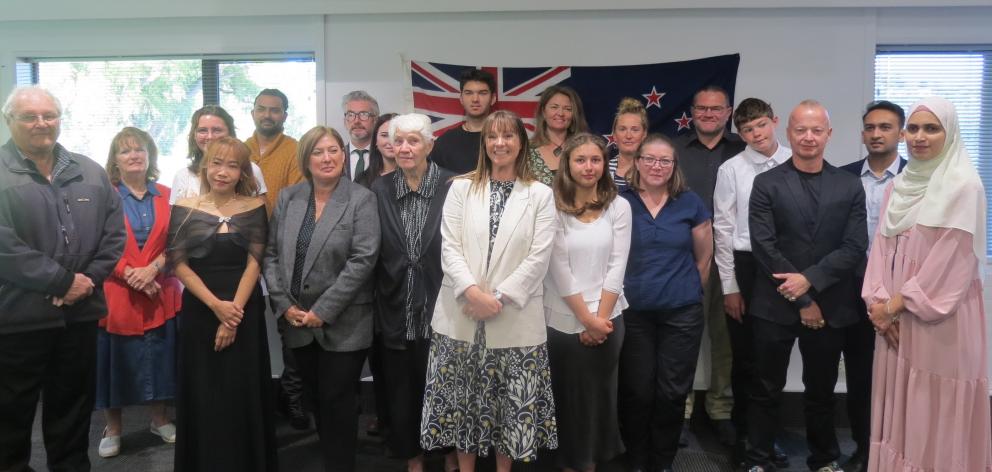 New citizens pose for a photo with Central Otago District Mayor Tamah Alley after their ceremony...