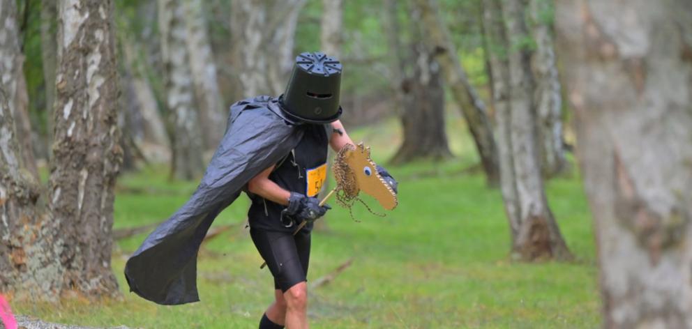 Race runner Pascal Saker gallops along the track on the back of a hobby horse. PHOTO: BRAD SPIERS