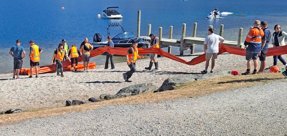 Staff from the Otago regional and Queenstown Lakes district councils deploy a boom at a simulated...