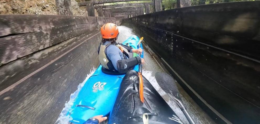 Jeremy Norbury (front) and friend Zack Mutton kayaking down a drainage ditch in Hokitika. Photo:...