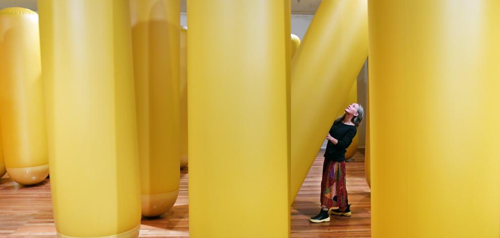 Dunedin Public Art Gallery technical specialist Jen Boland in among the forest of yellow...