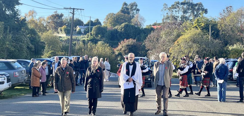 Archdeacon the Ven Bernard Wilkinson (centre) leads the procession from Maheno School to the...