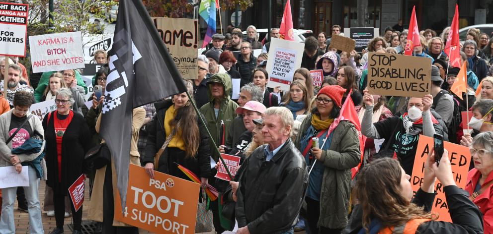 People listen to speakers at the Protect Pay Equity protest, held at John Wickliffe Square,...