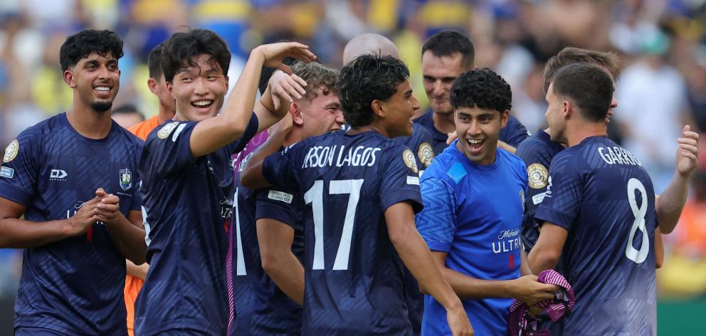 Auckland City players celebrate after drawing with Boca Juniors at the Club World Cup yesterday....