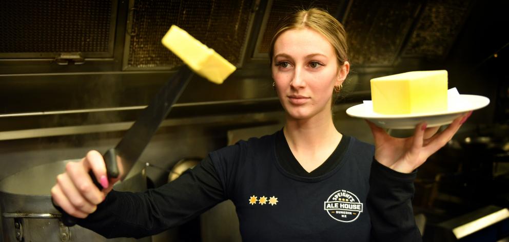 Speight’s Ale House Dunedin staff member Bella Mangos holds up a sliced pound of butter. PHOTO:...