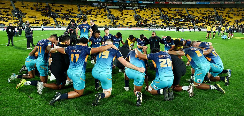 Moana Pasifika form a huddle after the round 16 Super Rugby Pacific match between Hurricanes and...