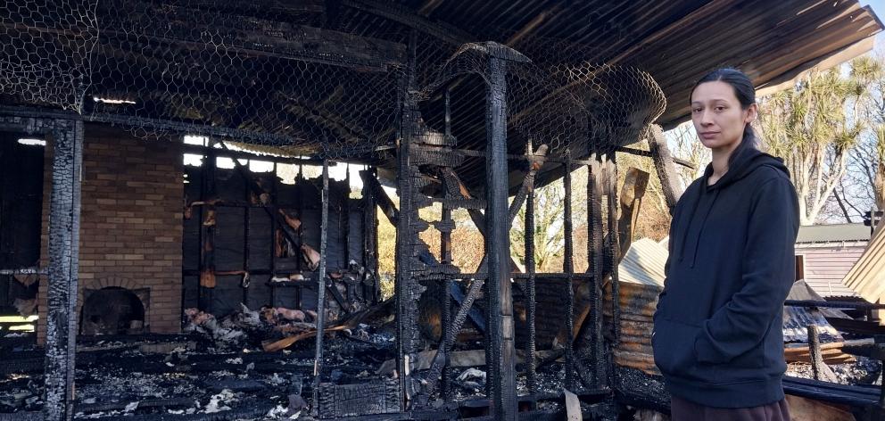 Heeni Millar stands inside the remains of her family home, which burned down last Thursday. PHOTO...