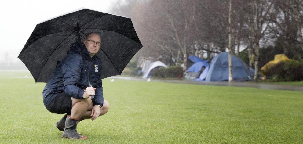 Southern Football chief executive Dougal McGowan squats in front of the Kensington Oval...