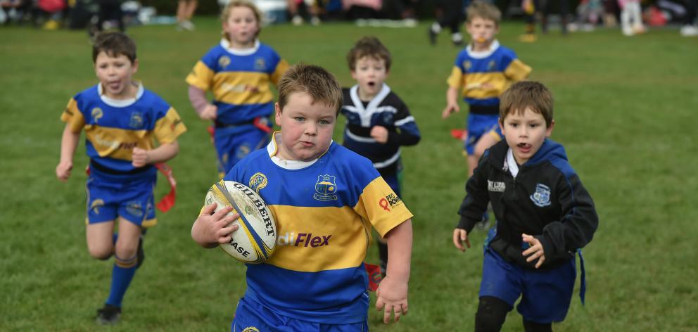 Taieri Gold player Ollie Batt, 6, sprints towards the try line to score against Kaikorai.