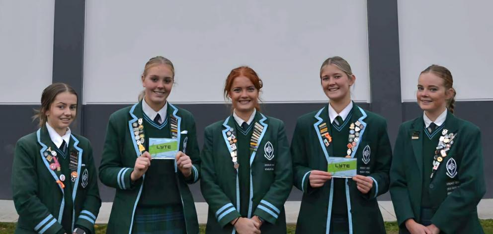 Showing off their prototype product are (from left) production manager Briar Allan, 18, chief...