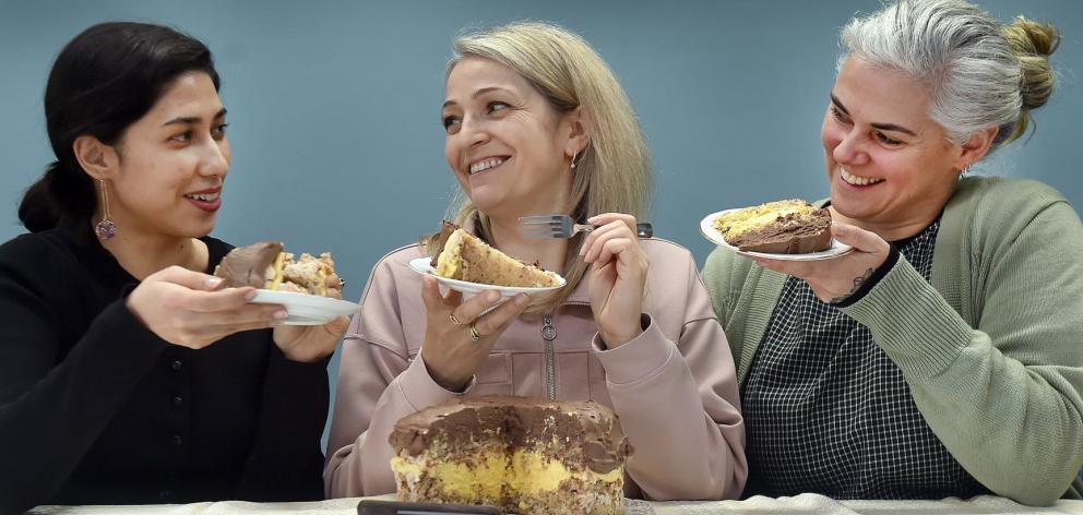 Kiana Jalali ( left), Hanna Kryvonos and Hannah Molloy enjoy a slice of Kyiv cake. Photo: Peter...