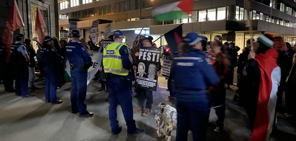 Protesters outside the Distinction Hotel this evening. PHOTO: PETER MCINTOSH