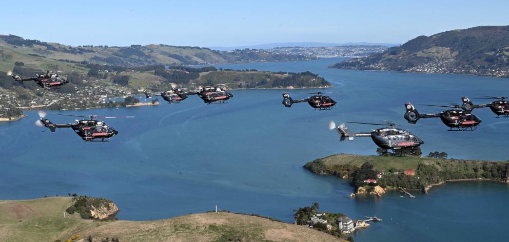 A fleet of rescue helicopters soar above Otago Harbour in formation yesterday. PHOTO: STEPHEN...