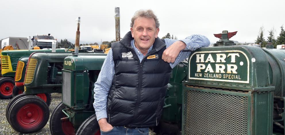 Allan Dippie with one of the over 100 tractors and other vehicles that will be auctioned on...