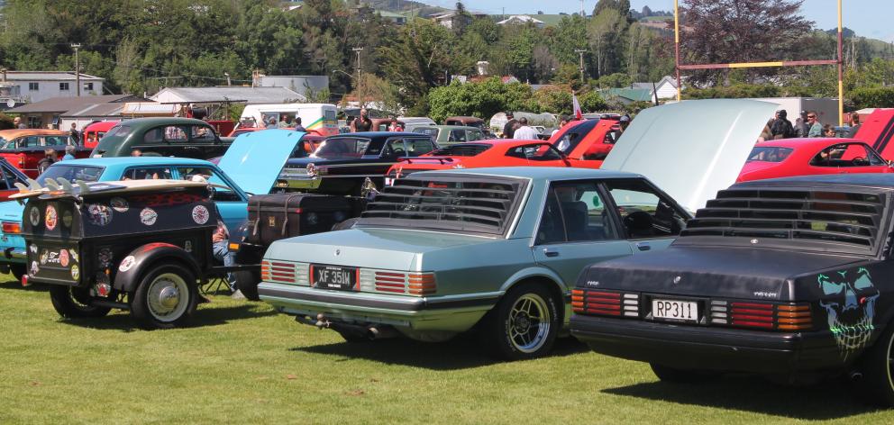A brace of Ford Falcons beside an appropriately-branded trailer.