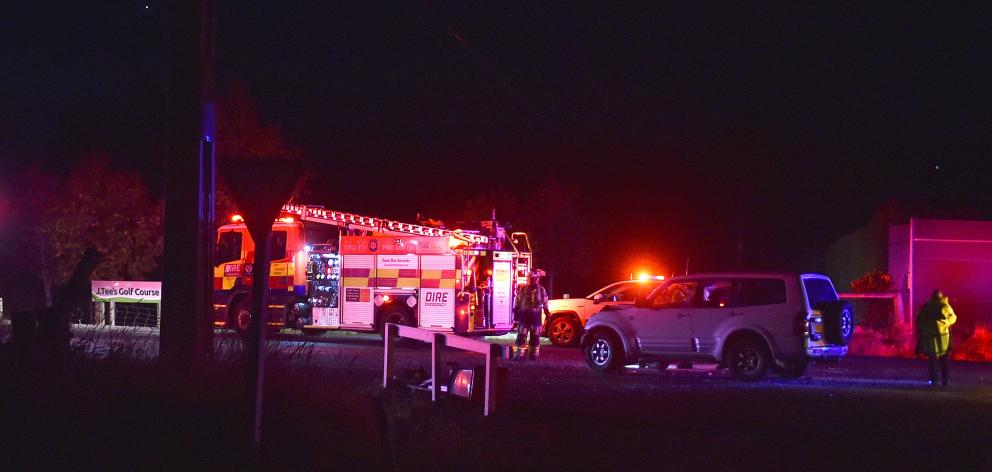 Emergency staff at the scene on Friday night. PHOTO: PETER MCINTOSH