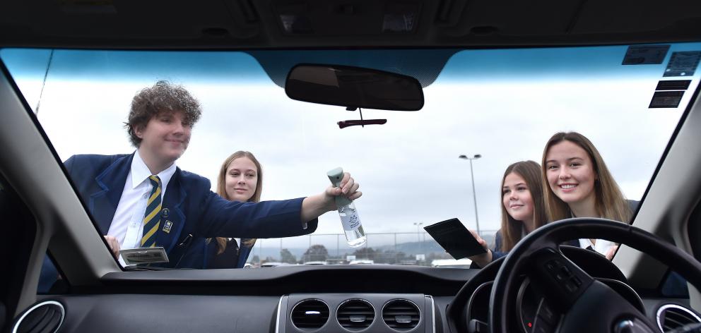 Trying out their Winter Warriors windscreen concoction are Taieri College students (from left)...