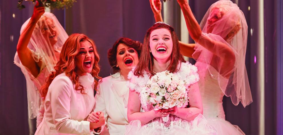 Muriel Hyslop (Maggie McKenna) tries on her dream wedding dress in a scene from Muriel’s Wedding...