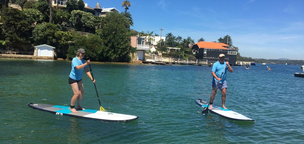 Watson’s Bay proved the ideal place for a stand-up paddle boarding lesson. PHOTO: TERRY MCDERMOTT...