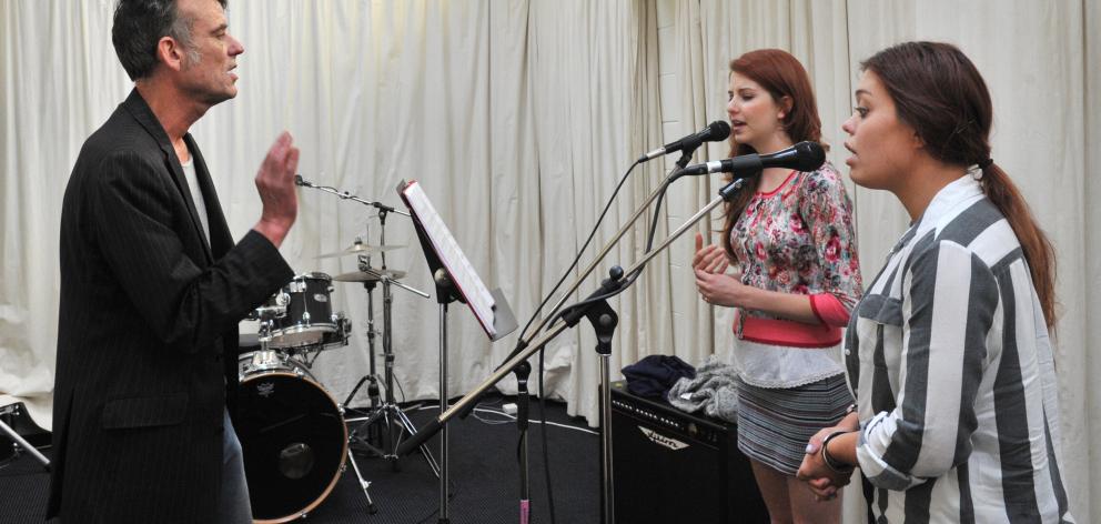 Graeme Downes and vocalists Molly Devine (left) and Kylie Price rehearse a song  for the  Tally...