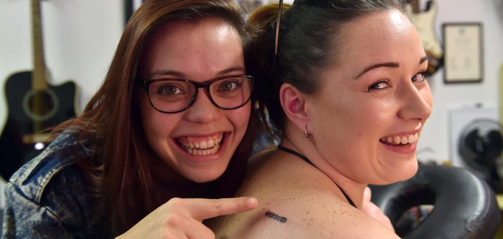 Kylie Price (left) points at friend Stephanie Seyb’s  Ed Sheeran tattoo, earlier this year. Photo...