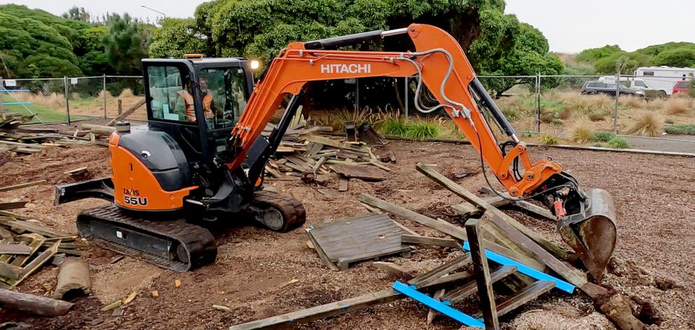 Contractors demolish the fort-playground at Thomson Park on Wednesday morning. Photo: Geoff Sloan
