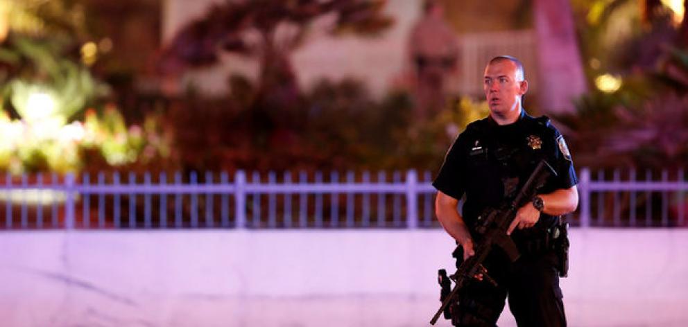 A law enforcement officer stands in front of the Tropicana hotel-casino after the mass shooting at a music festival in Las Vegas. Photo: Reuters