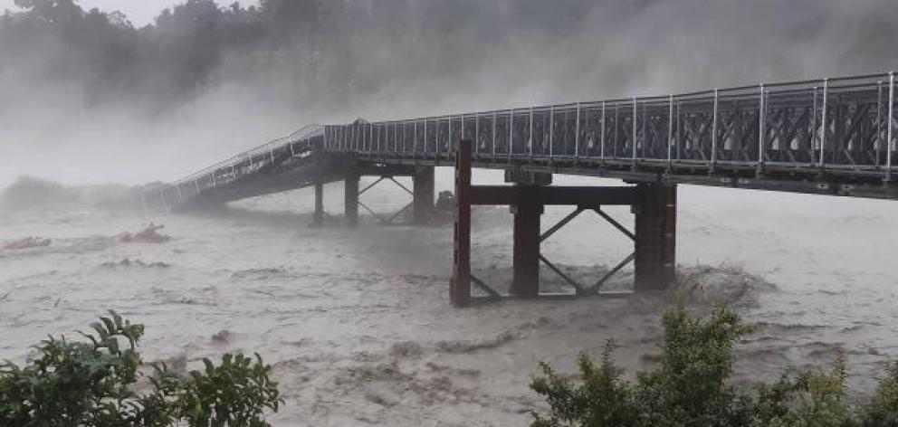 Much of the West Coast is cut off after a section of the Waiho River bridge was swept away. Photo...