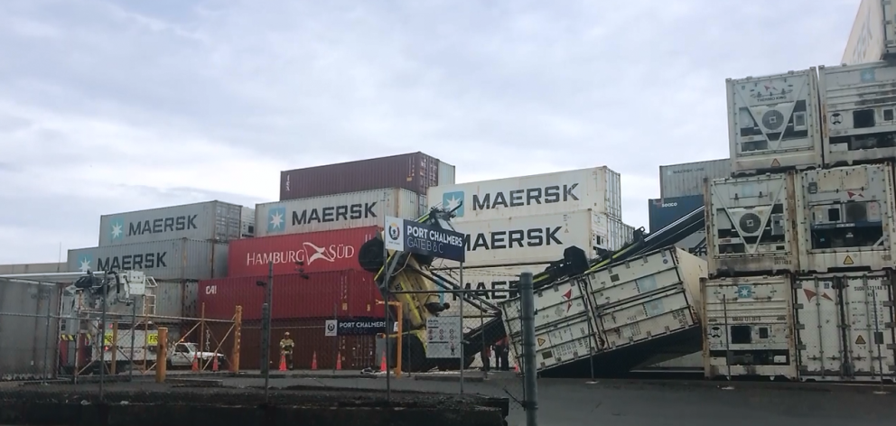 A gust of wind toppled this sidelifter as it lifted a container at Port Otago yesterday. PHOTO:...